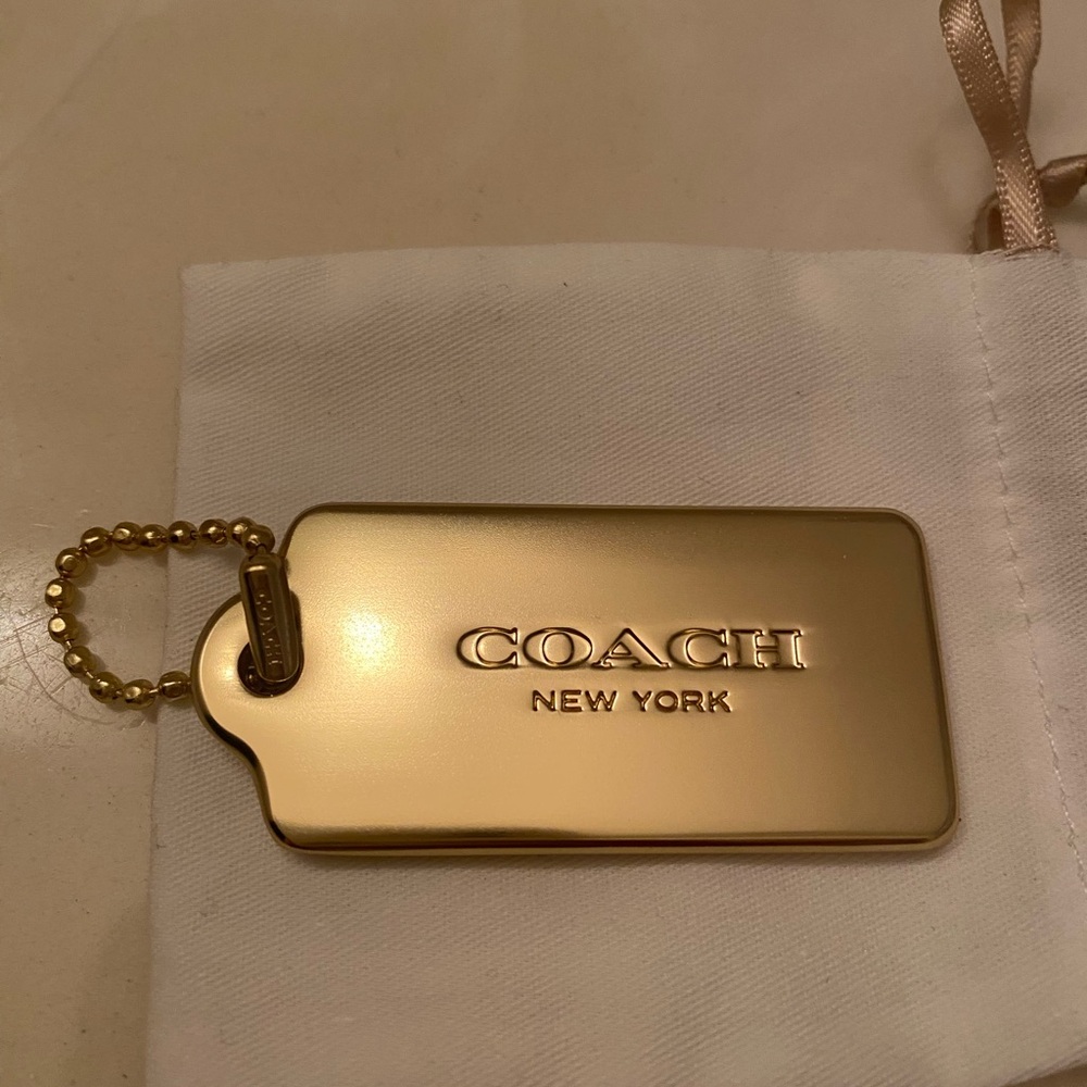 Coach metallic gold tag